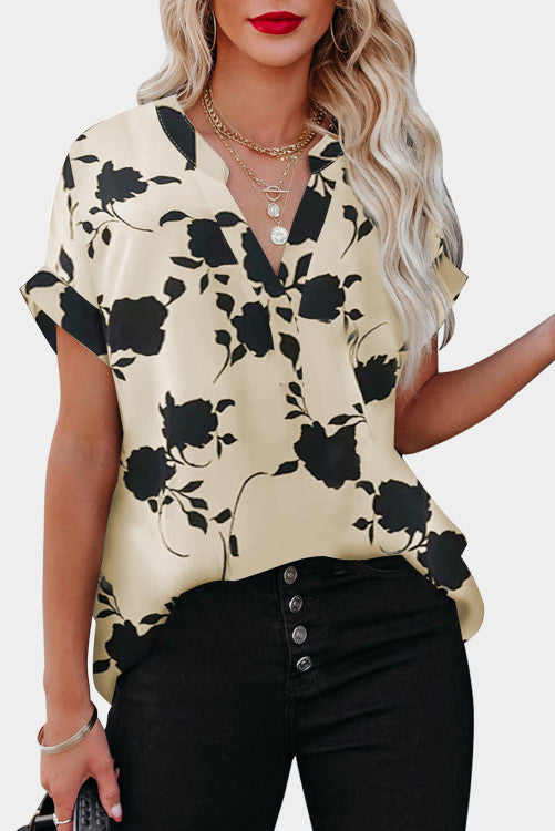 Cream and black floral short sleeve blouse. Has raglan style with cuffed short sleeves and v-neck. 100% polyester textured lightweight fabric. This is roomy for sizes!! 