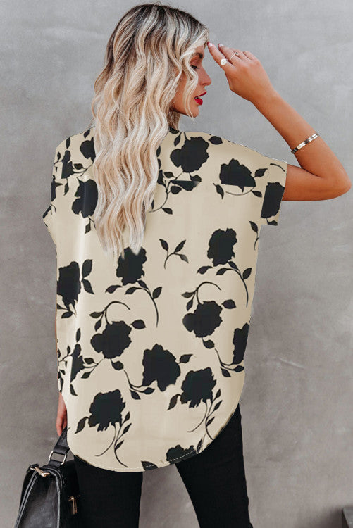 Cream and black floral short sleeve blouse. Has raglan style with cuffed short sleeves and v-neck. 100% polyester textured lightweight fabric. This is roomy for sizes!! 