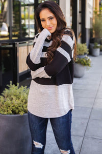 •Featuring a color block detail in gray and black.  •Trimmed with horizontal stripes and drawstring.  •High quality fabric keeps you free and comfy with every move.  •Just throw this on over your favorite graphic tee, jeans, and sneakers!
