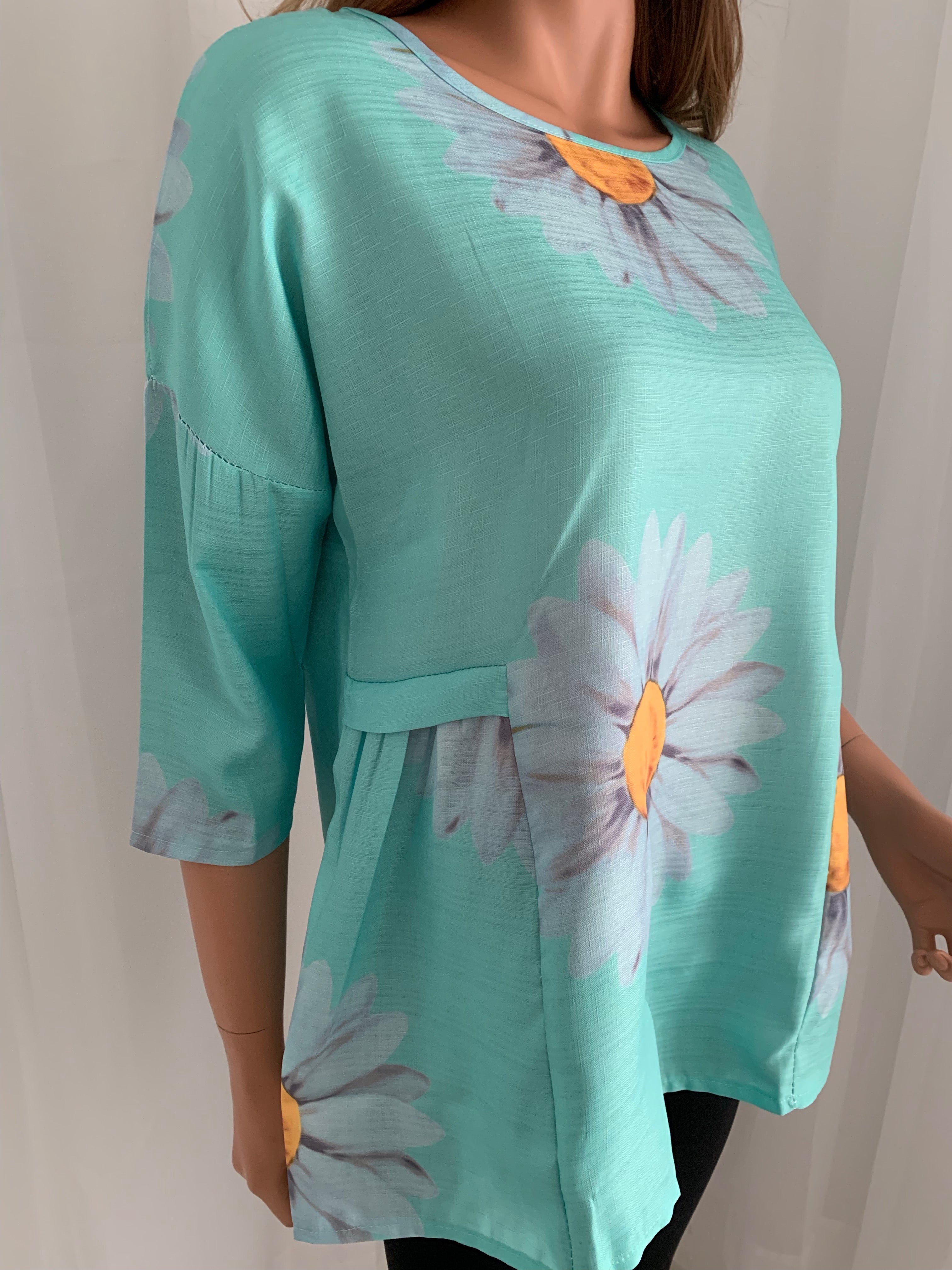 Relaxed fit cotton blend top with 3/4 sleeve. Pretty sea green color and trending daisy design makes this top wearable for any occasion.  Note: No stretch so they fit on the smaller end of size guide. This is a nice quality top! 