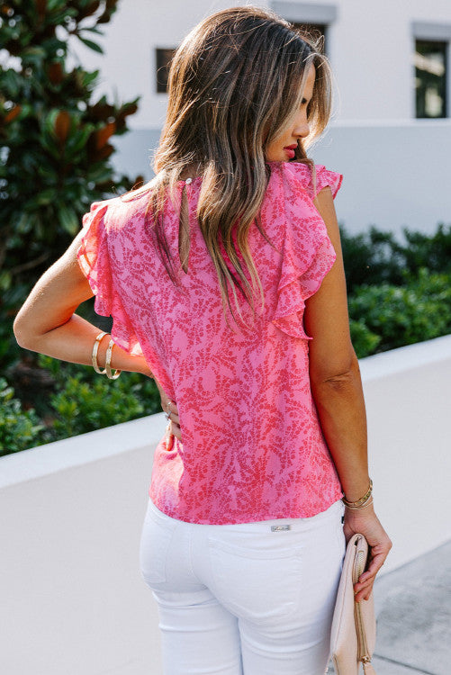 Pink floral print crepe with ruffled flutter cap sleeves blouse. Has back button keyhole closure. Nice relaxed fit top made of lightweight polyester blend no stretch fabric. Great top for warm sunny days. Front bodice is lined. 