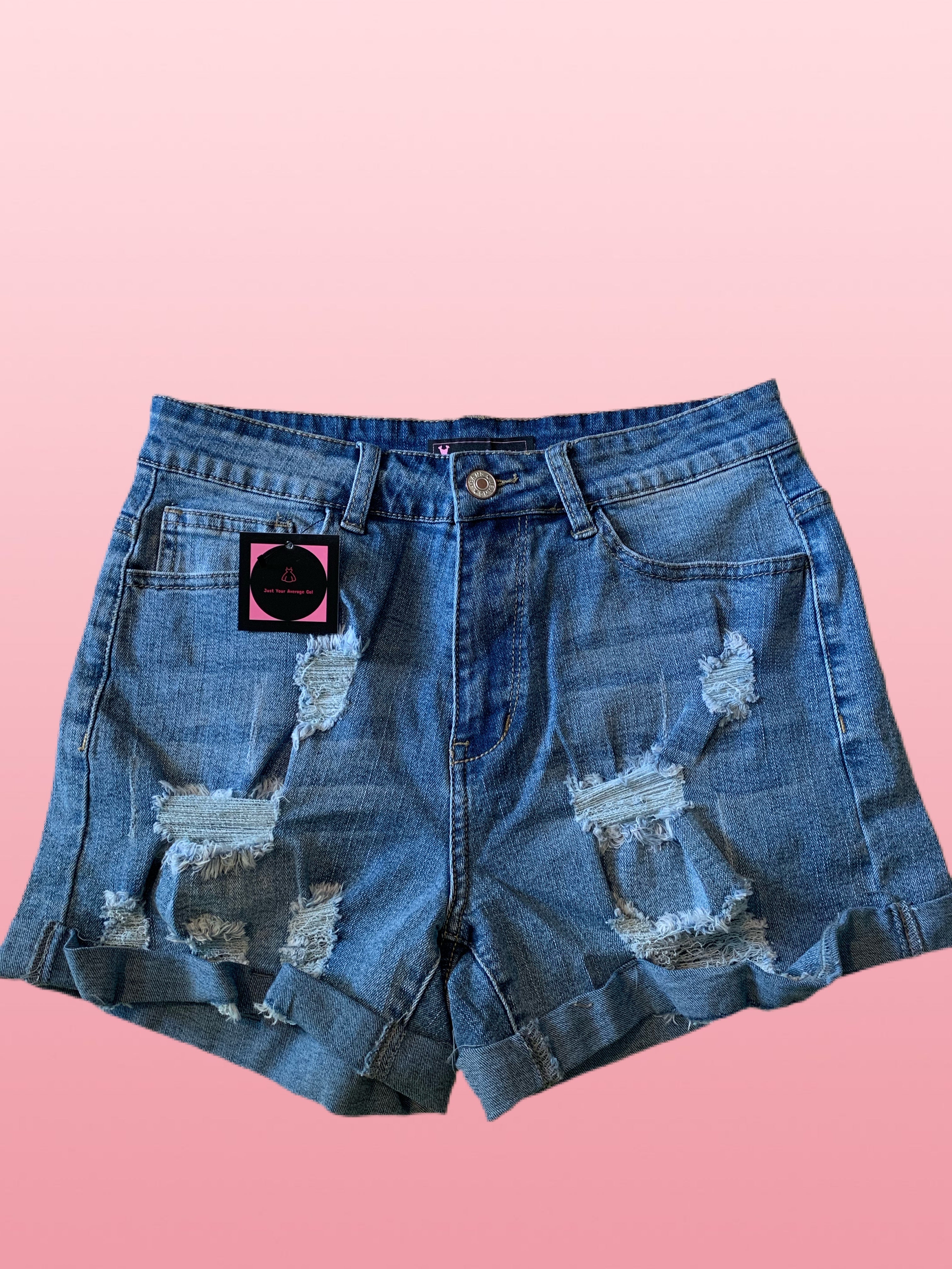 Retro distressed stretchy denim shorts. Mid-rise with rolled cuff hem, 5 pockets, and zip fly bronze button closure. Fabric 63%Cotton+35%Polyester+2%Spandex 