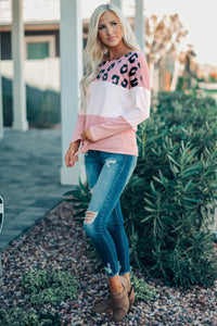 This Pink Color Block Leopard Tie Top Is So Adorable!  •You can never have too much leopard.  •Has a light color block print fabric and long sleeves.  •Tie in the front and a scoop neck.  •Is a roomier fit, downsize if you don’t want it to fit loose. 