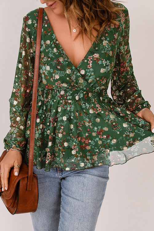 Green floral print blouse with elastic cuffs and waistband for a fitted look. Is fully lined. Designed with a V-Neck and peplum style for a carefree fit. Pair it with jeans, dress pants or even skirts and shorts. This top runs snug so you might want to size up from your regular size from my clothing line. Polyester. 