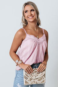This pink tank top is a lightweight cool cotton blend fabric. Swiss dot texture design. A v-cut neckline with delicate lace trim detailing. Adjustable spaghetti straps for a perfect fit. A relaxed silhouette that falls into a straight hemline. Perfect lightweight flowy tank for hot summer days. 