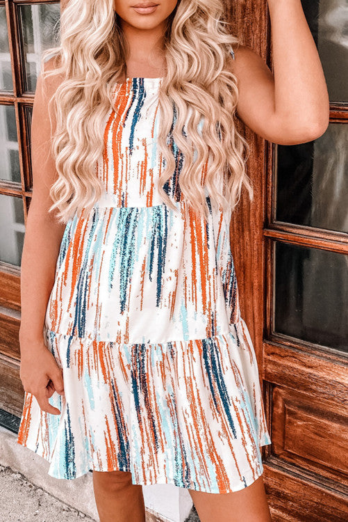 Boho styled sundress with splashed verticals stripes of blues, oranges and aquas. Nice cool lightweight fabric makes this perfect for warm sunny days.