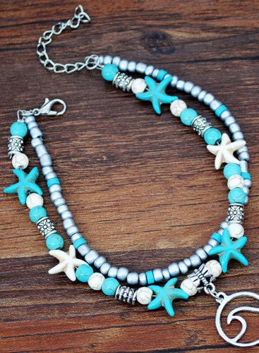 Turquoise and white double string beaded anklet. Made of round beads and white starfish with a metal attachment. Adjustable length clasp for a comfortable fit. 