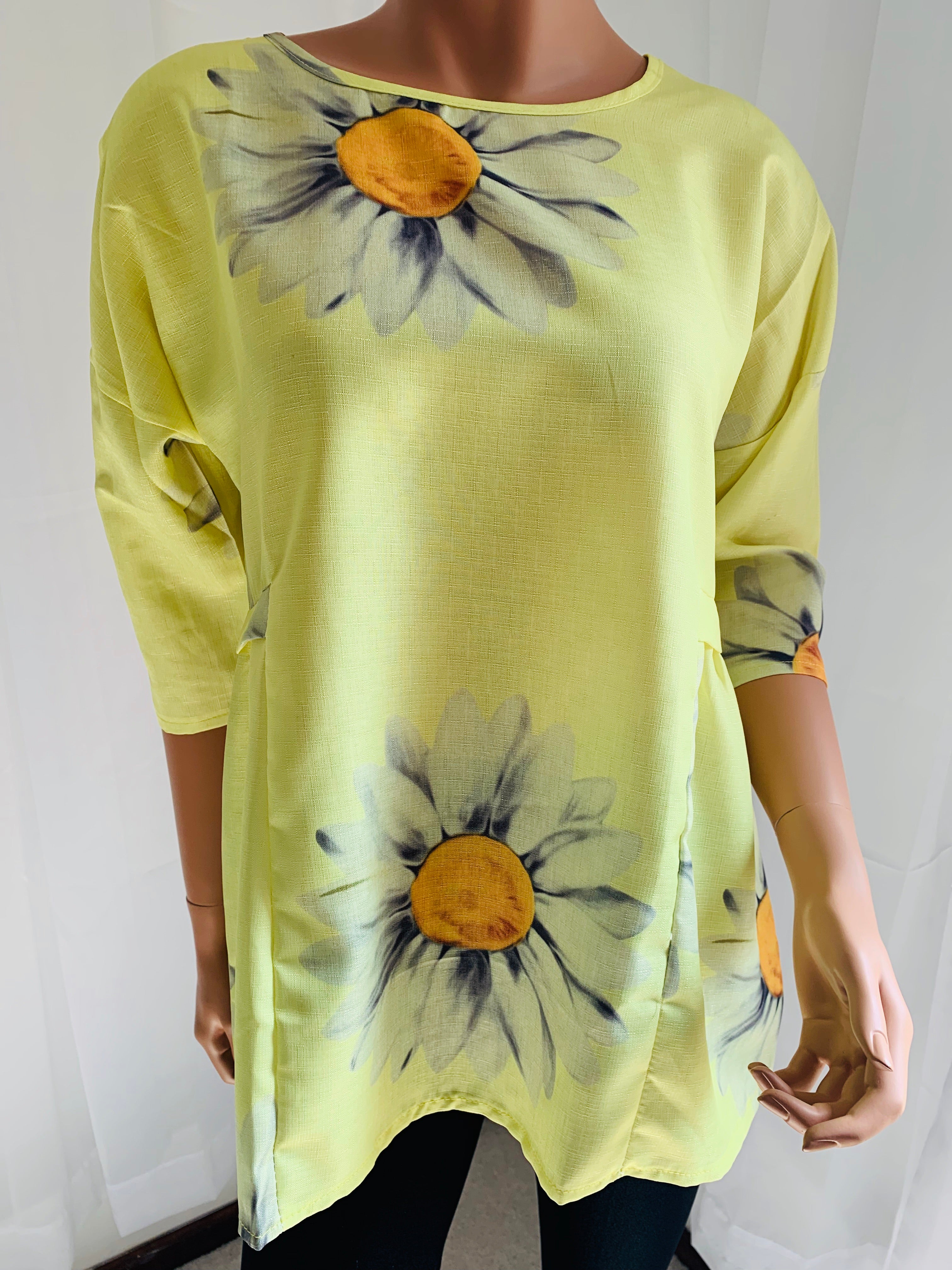 Relaxed fit cotton blend top with 3/4 sleeve. Vivid yellow color and trending daisy design makes this top wearable for any occasion.  Note: No stretch so they fit on the smaller end of size guide. This is a nice quality top! 