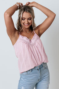 This pink tank top is a lightweight cool cotton blend fabric. Swiss dot texture design. A v-cut neckline with delicate lace trim detailing. Adjustable spaghetti straps for a perfect fit. A relaxed silhouette that falls into a straight hemline. Perfect lightweight flowy tank for hot summer days. 