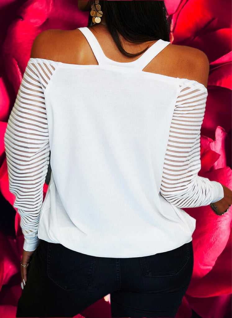 Lightweight knit long-sleeved top with sequined red heart design on front. V-neck cold shoulder sleeves. Stretchy elastic around shoulders for better fit. Banded hem is stretchy. Is very roomy top! 