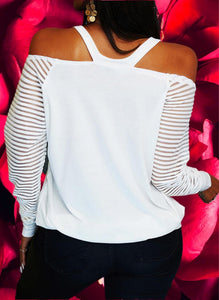 Lightweight knit long-sleeved top with sequined red heart design on front. V-neck cold shoulder sleeves. Stretchy elastic around shoulders for better fit. Banded hem is stretchy. Is very roomy top! 
