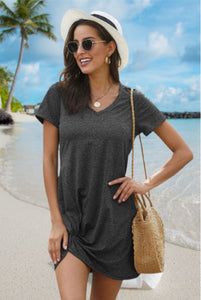 Charcoal black tri-blend V-neck twist knot tee dress made with lightweight dri-fit type fabric. Has trendy twist knot hemline and classic t-shirt style with cuffed short sleeves. Perfect for hot summer days. 