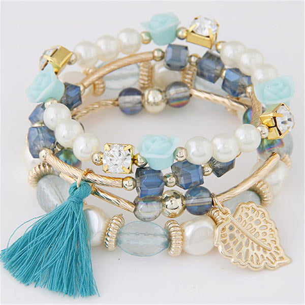 Turquoise, gold and white beads, make up this fashionable 4-piece bracelet set. Stretch elastic bands with beautiful beads of turquoise, white, gold and blue. Also adorned with gold metal rhinestone beads, turquoise tassels and metal leaf tags. Beautiful bracelet set, very nice quality! 
