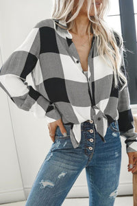 Black and white plaid button down blouse, turn down collar, with v-neck style and button down starting at the v-neck. Sizes small, medium, large, extra large, and 2X. $24.00.