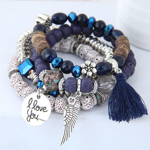 Navy, silver and white beads, make up this fashionable 4-piece bracelet set. Stretch elastic bands with beautiful beads of navy, silver, browns and white. Also adorned with metal floral, tassels and metal tags. 