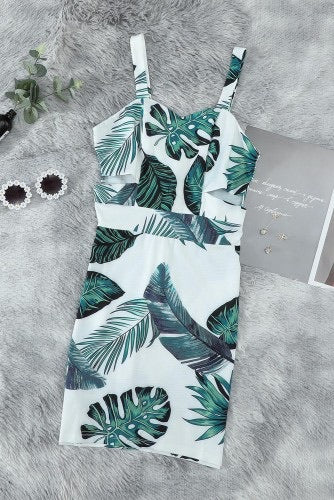 Vibrant white with green tropical print mini dress. The classic sweetheart styling creates a flattering silhouette with trendy side cut-out detailing. High quality fabric offers you a soft and comfortable feel. Dress is a fitted style.