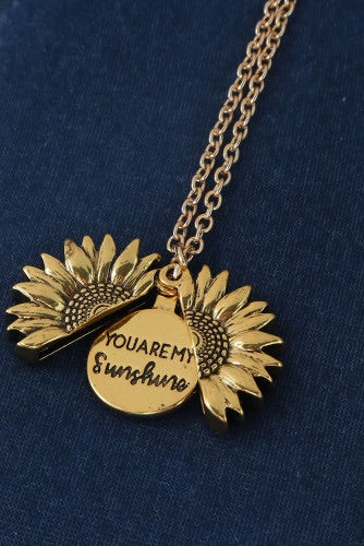 Cute gold sunflower necklace that opens up with a saying inside to brighten up your day.