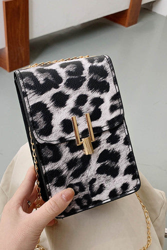 Black leopard print crossbody purse. Trendy and classy purse perfect to hold the necessities when going out or to a fancy occasion. Beautiful gold accent magnetic closure with long gold chain strap. Purse is made of PVC. 