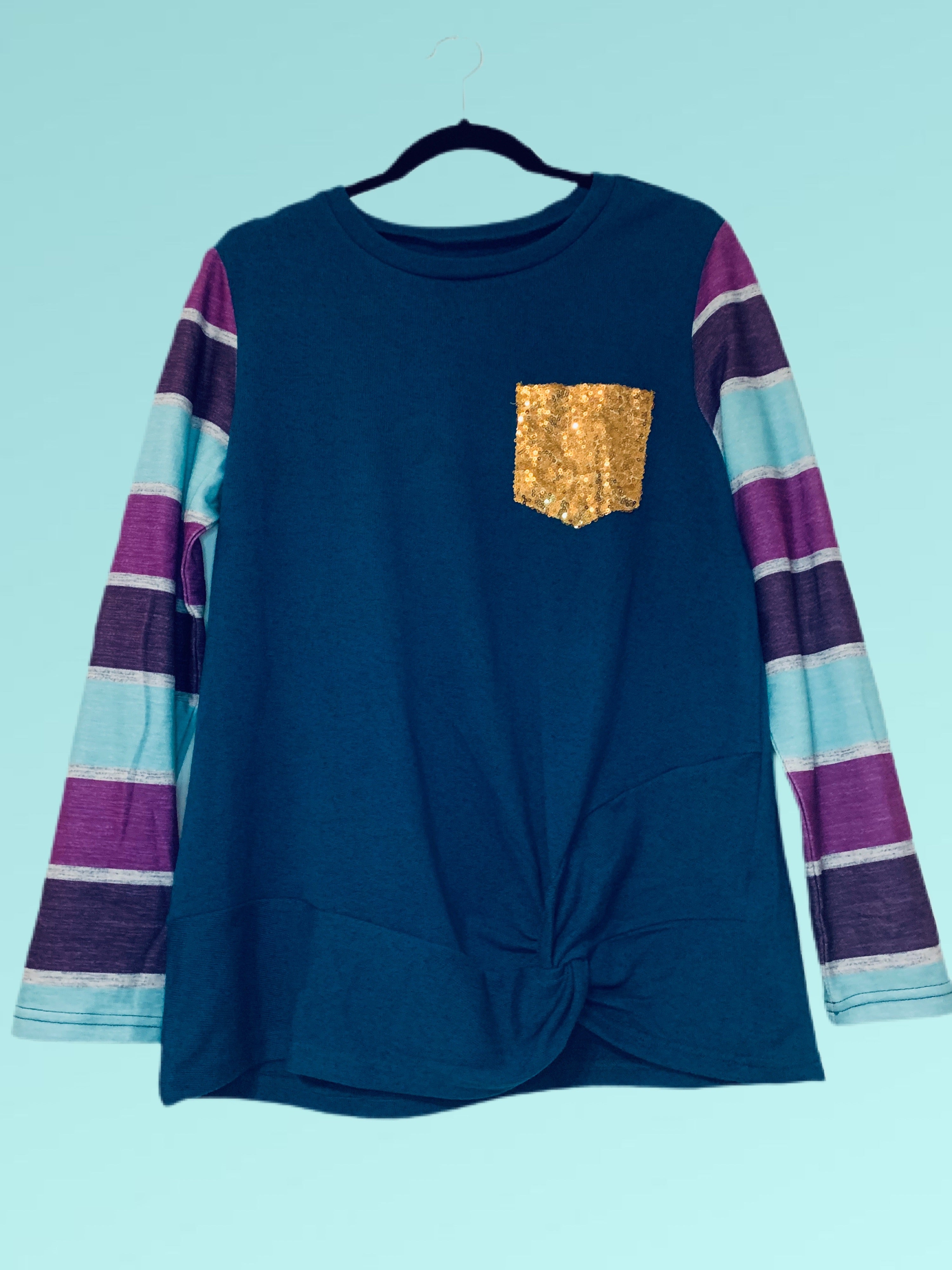  •Sequin pocket to add sparkle to your holiday.   •Colorful stripes are fun and festive.   •Round hemline trimmed with special twist knot.  •Loose and comfy fit!  •Soft stretch knit fabric.  •Runs bigger could down size!