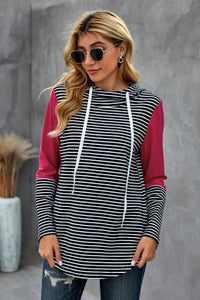We love a good hoodie that you can layer with, especially as the weather is only going to get cooler.  •This is a great transition piece as you can wear alone and then add a cute coat later on for extra warmth.  •Flattering fit striped print, solid color accent on sleeves.