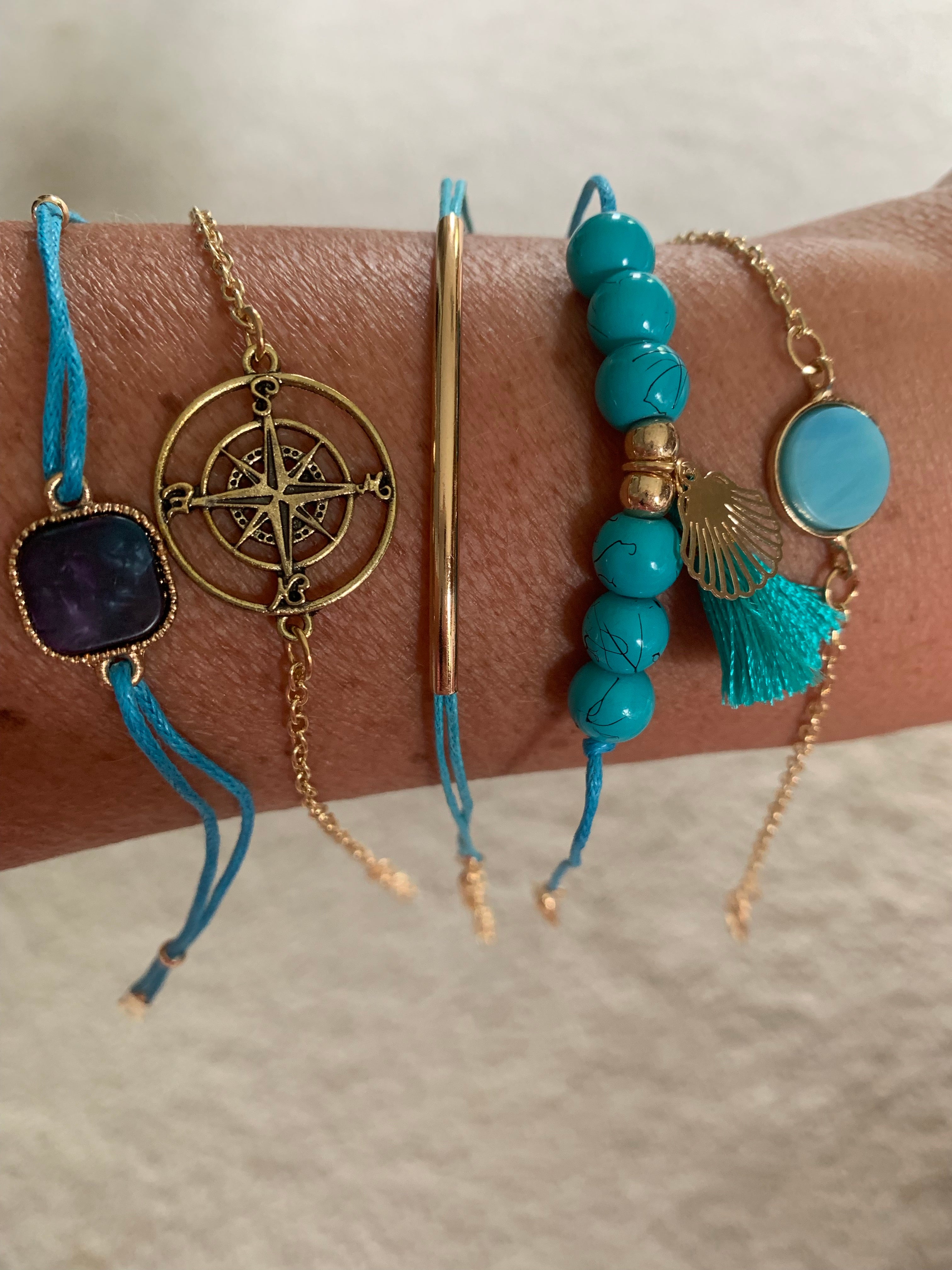 Turquoise beaded. gold chain, and strings adjustable bracelet set. Contains 6 pieces. Can be worn separate, all together, or any way you want to wear them!
