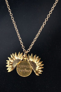 Cute gold sunflower necklace that opens up with a saying inside to brighten up your day.
