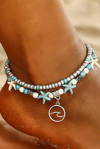 Turquoise and white double string beaded anklet. Made of round beads and white starfish with a metal attachment. Adjustable length clasp for a comfortable fit. 